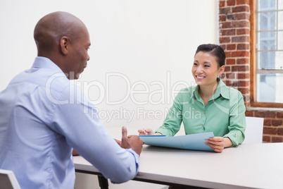 Casual business people talking at desk