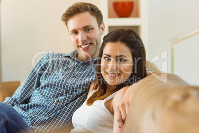 Happy young couple relaxing on the couch