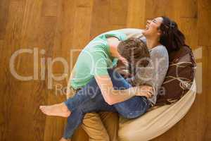Cute couple laughing together on beanbag