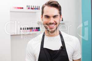 Handsome hair stylist smiling at camera