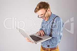 Geeky businessman using his laptop