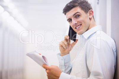 Smiling technician on the phone holding a document