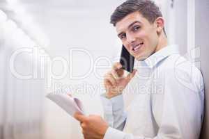 Smiling technician on the phone holding a document