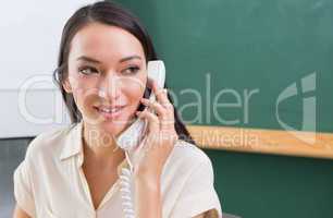 Businesswoman using telephone