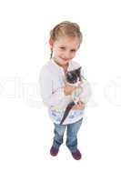 Smiling little girl with her cute kitten