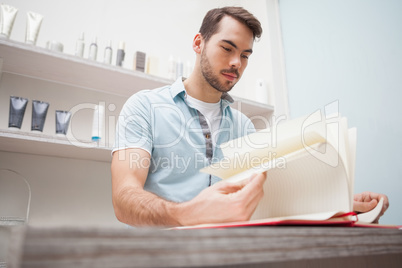 Smiling hairdresser with stock book