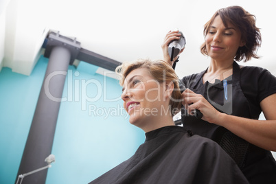 Hairdresser drying a customers hair