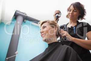Hairdresser drying a customers hair