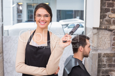 Pretty hair stylist smiling at camera