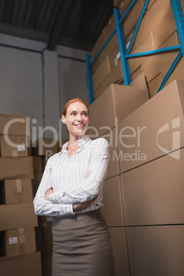 Female manager with arms crossed in warehouse