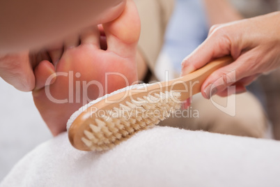 Customer getting pedicure at nail salon