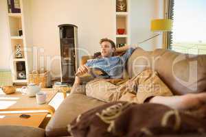 Young man reading on his couch