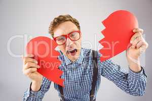 Geeky hipster holding a broken heart