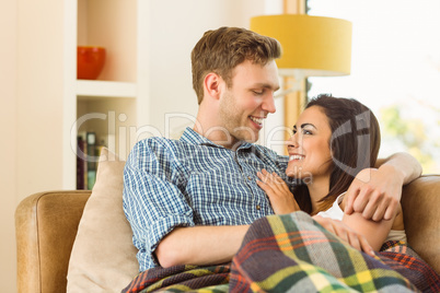 Happy young couple relaxing on the couch