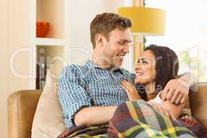 Happy young couple relaxing on the couch