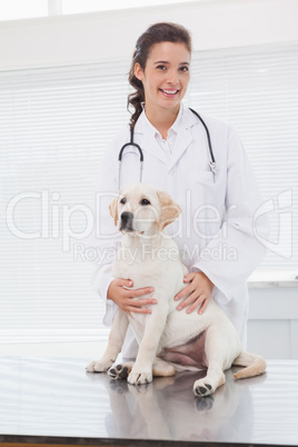 Smiling veterinarian examining a cute dog