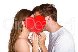 Side view of romantic couple holding heart