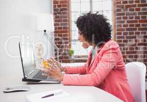 Stressed casual businesswoman sitting at desk
