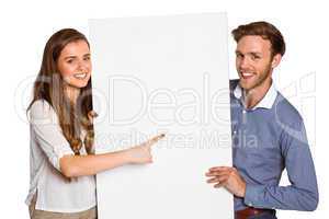 Happy young couple with blank board