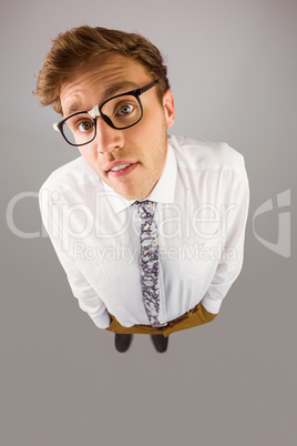 Young geeky businessman looking at camera