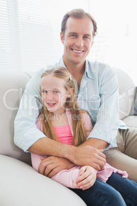 Casual father and daughter smiling at camera