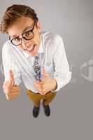 Young geeky businessman showing thumbs up