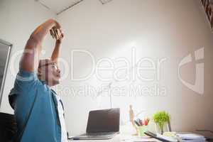 Casual businessman stretching in chair