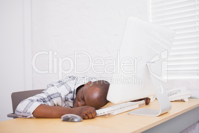 Casual businessman sleeping at his desk