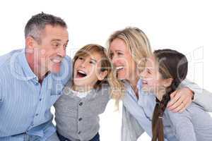 Happy family with two children smiling and hugging