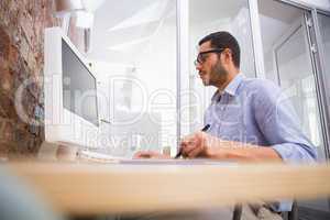 Man working at desk with computer and digitizer