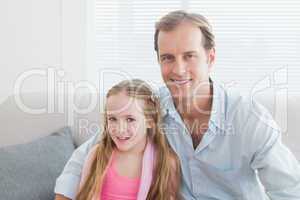 Casual father and daughter smiling at camera