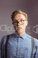 Geeky hipster covered in kisses