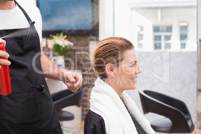 Handsome hair stylist with client