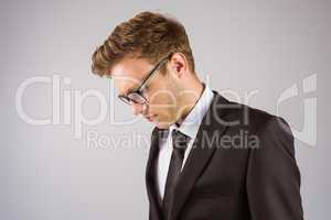 Young handsome businessman looking down