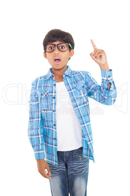 Cute boy pointing up with finger