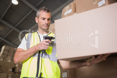 Worker scanning package in warehouse