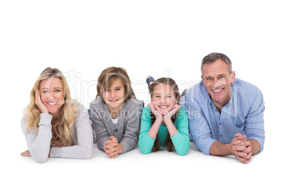 Cute family lying on the floor smiling at camera