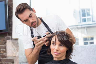 Handsome hair stylist with client