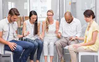 Business team holding hands while praying