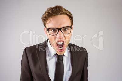 Young angry businessman shouting at camera
