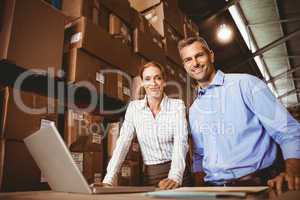 Colleague with laptop at warehouse