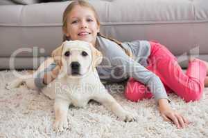 Cute little girl with her puppy on couch