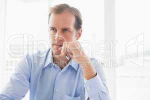 Handsome businessman thinking by the window