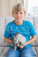 Cute little boy with his pet bunny