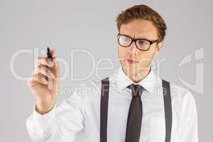 Geeky businessman writing with marker