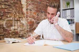 Man writing notes while on call