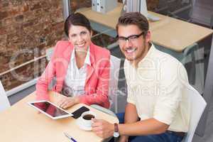 Business colleagues holding coffee cup and digital tablet