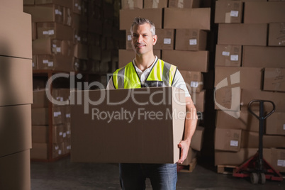Worker with box in warehouse
