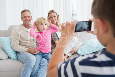 Son taking a photo of his family