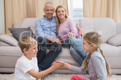 Happy parents with their children on floor